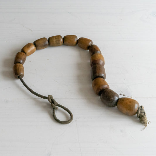 String of 13 small wooden Plumbers Bobbins