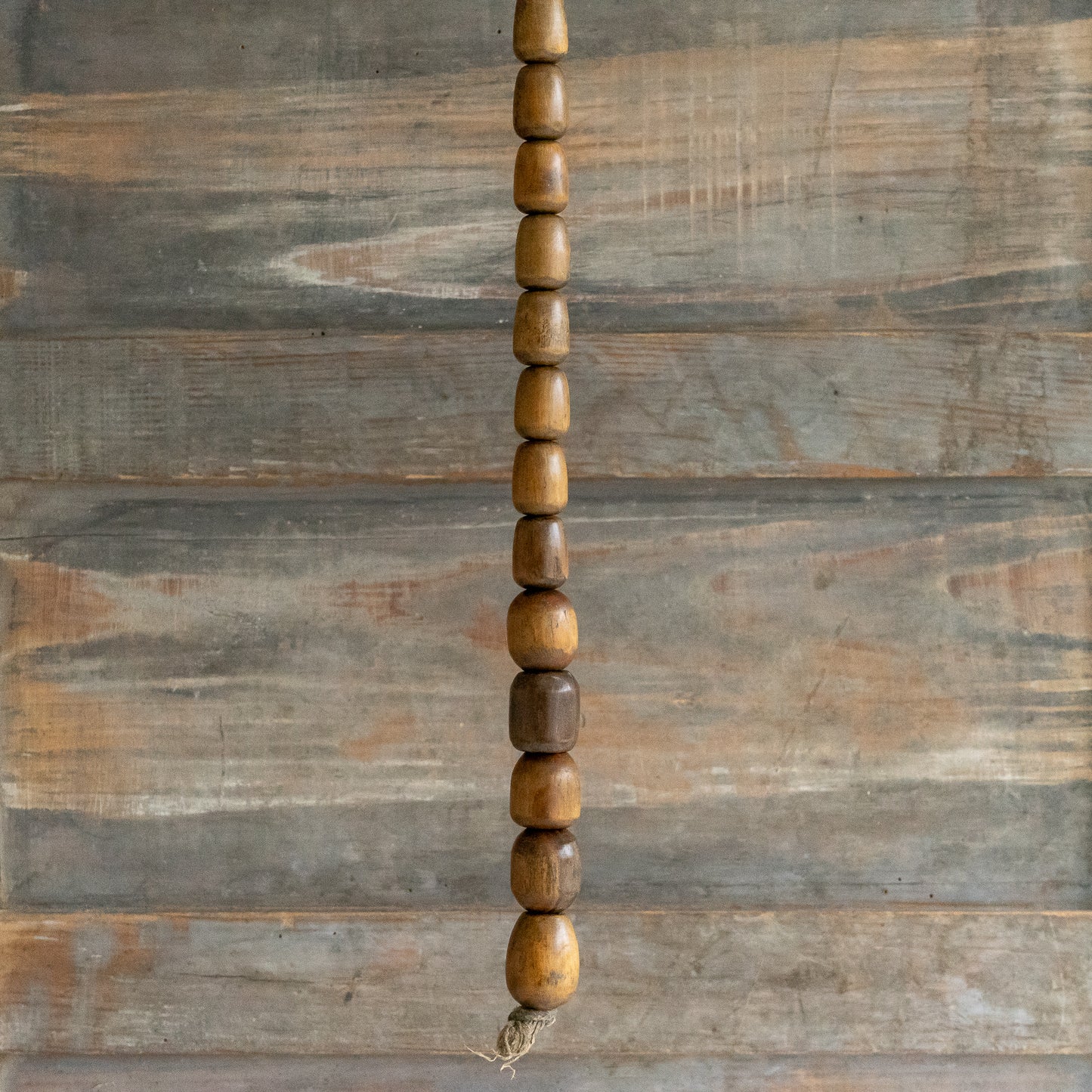 String of 13 small wooden Plumbers Bobbins