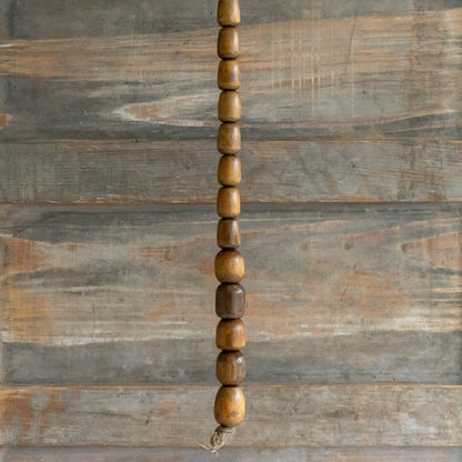 String of 13 small wooden Plumbers Bobbins