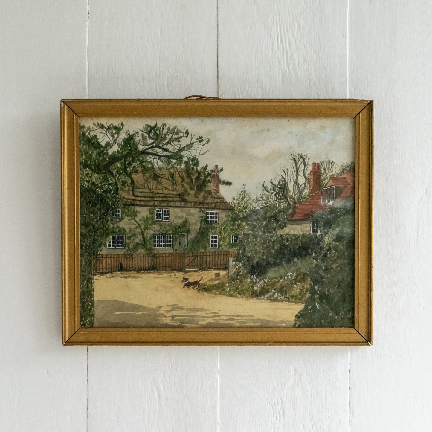 Framed Watercolour Painting of a Dog outside a Cottage