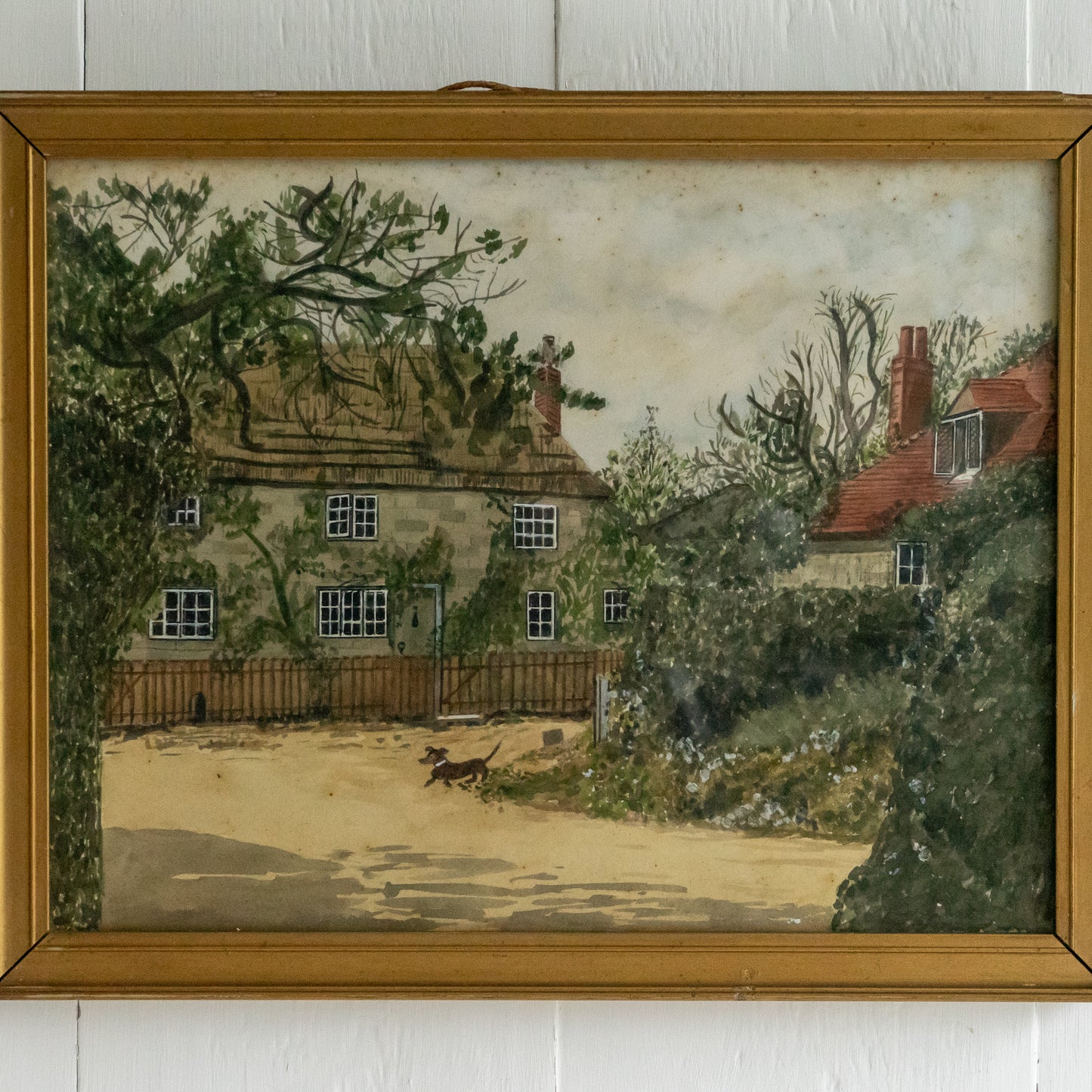 Framed Watercolour Painting of a Dog outside a Cottage