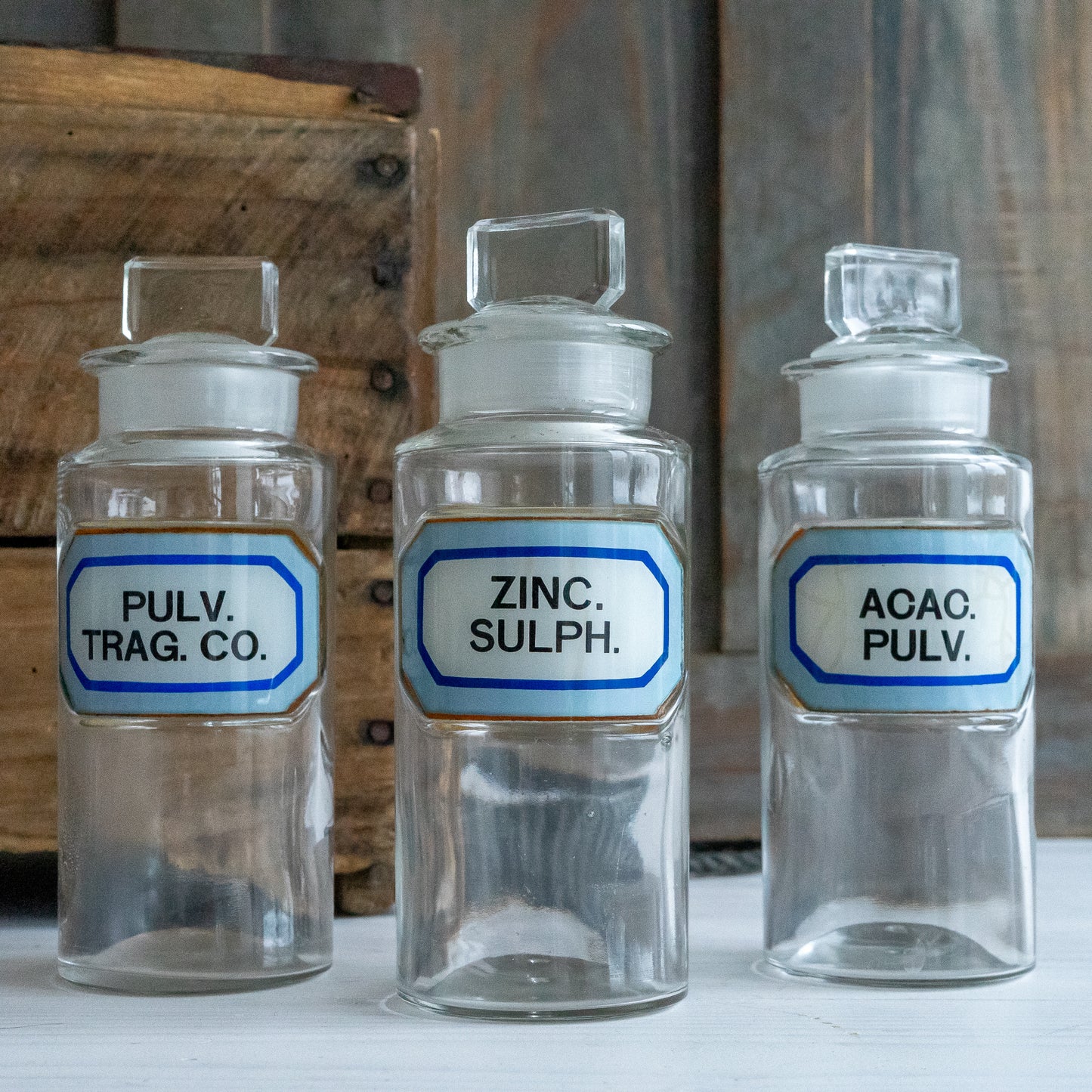 Vintage Glass Chemistry Bottles with Blue and White Labels